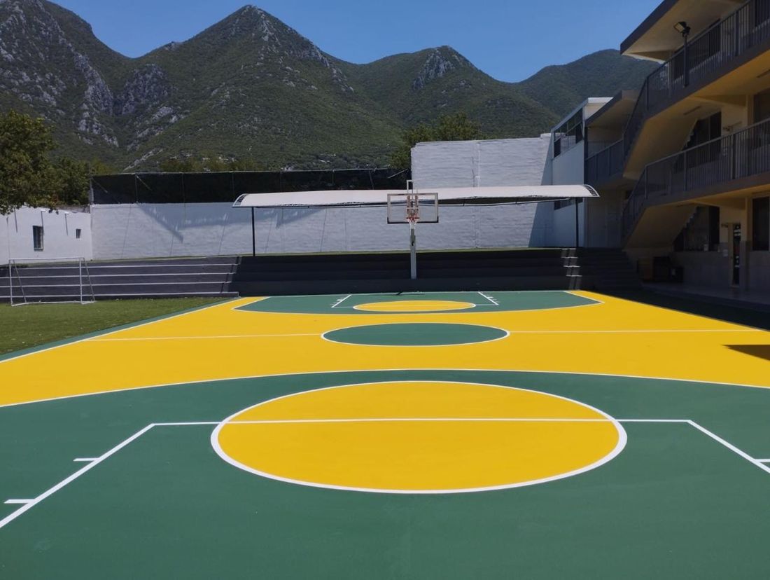 Cancha amarilla y verde con vista a las montañas